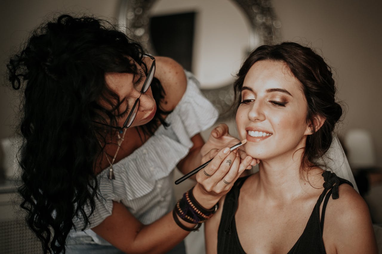 Makeup artist applying lipstick to a client