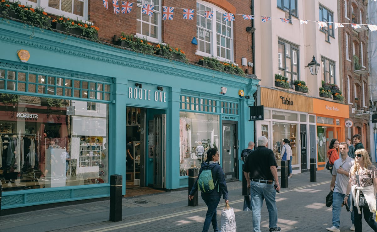 Friendly shop owner arranging products in a well-lit retail space