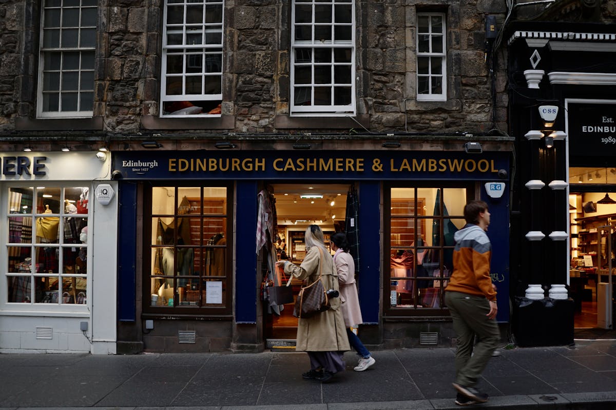 Friendly shop owner arranging products in a well-lit retail space
