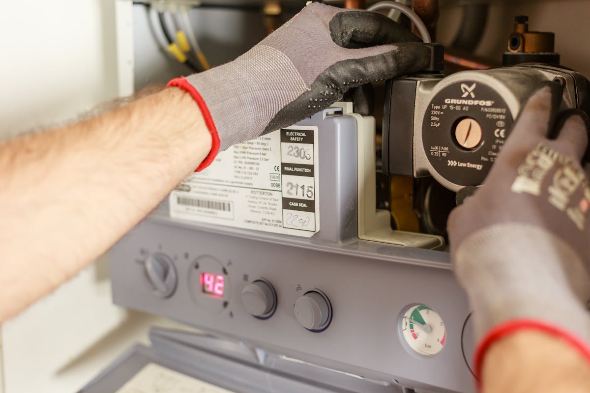 Heating engineer servicing a domestic boiler.