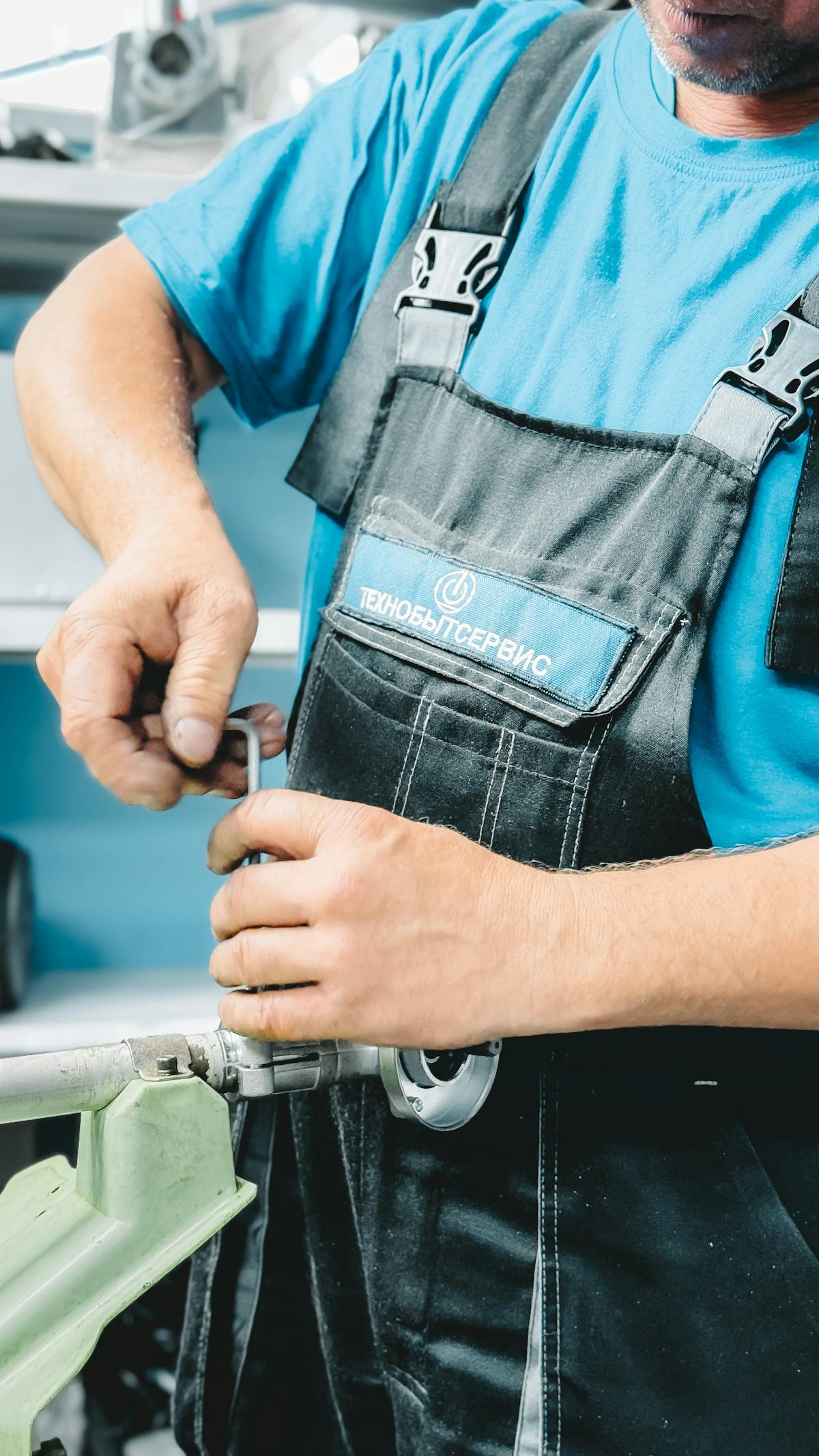 A plumber tightening copper pipework on a domestic installation.